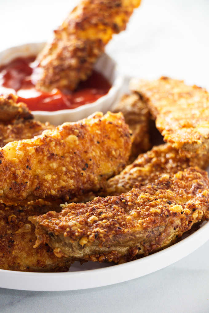 close up of Air Fryer potato wedges with a crispy cheese crust