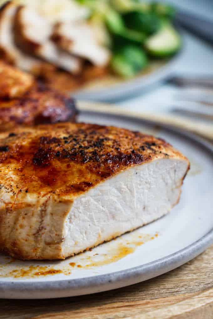 A chipotle air fryer pork chop sliced open to see the white meat.