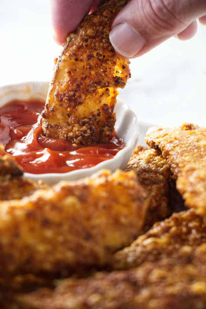 Air Fryer potato wedge being dipped in ketchup