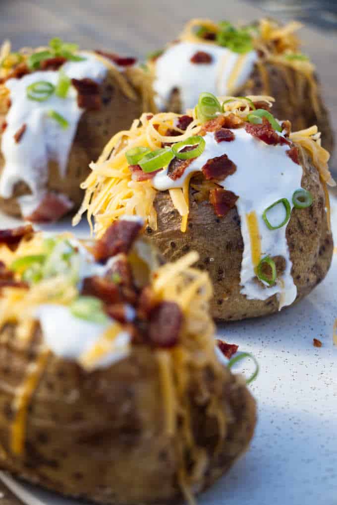 Air fryer baked potatoes on a serving platter