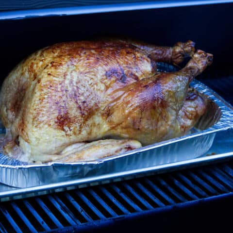 A Smoked turkey on the grill in a Traeger.