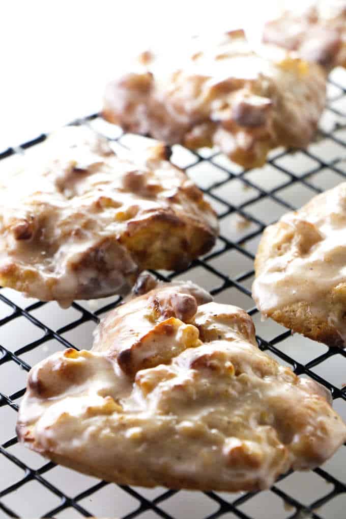 Fresh apple fritters on a cooling rack.