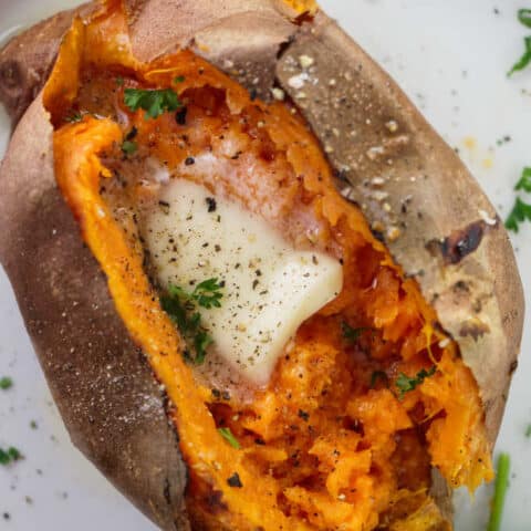 Air fryer baked sweet potato with butter, salt and pepper.