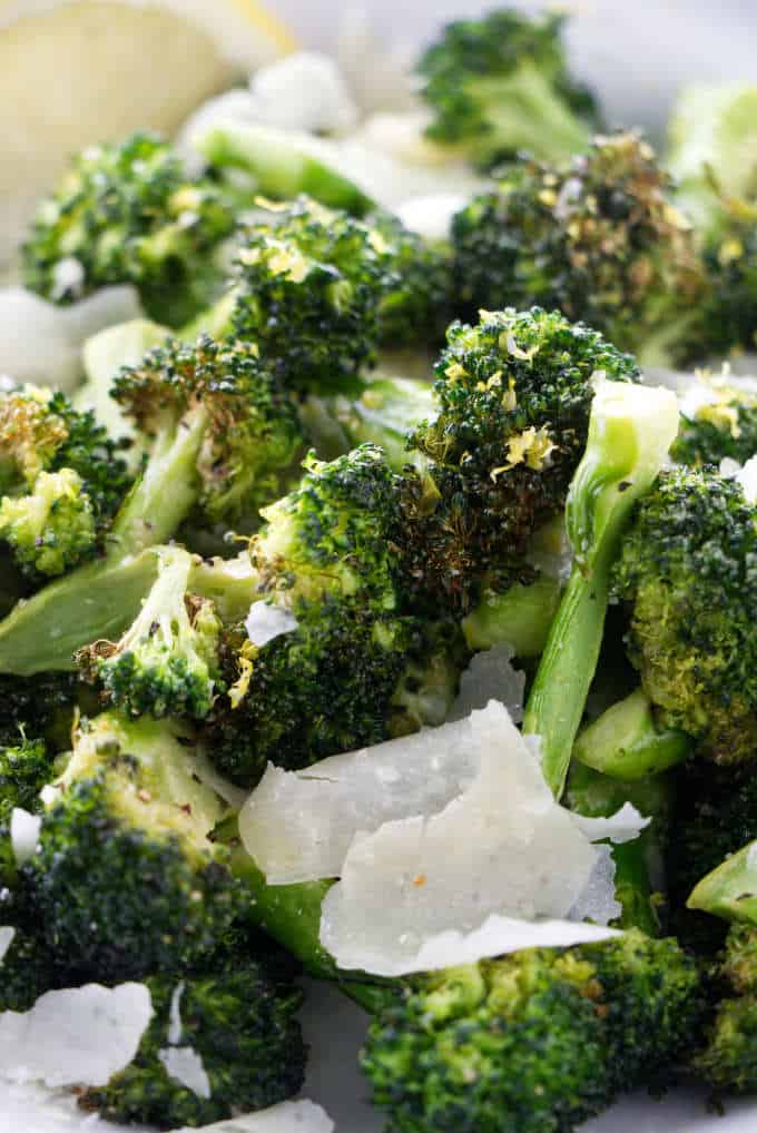 Close up of broccoli with parmesan and lemon.