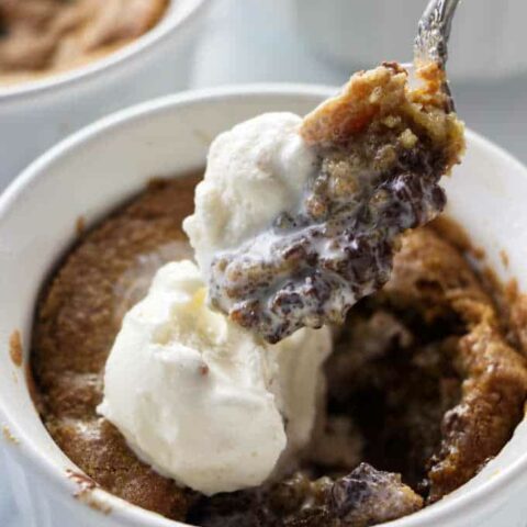 A spoon scooping into a deep dish cookie bowl.