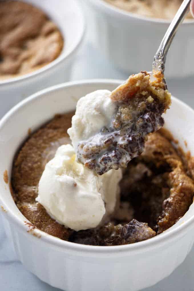 A spoon scooping into a deep dish cookie bowl.