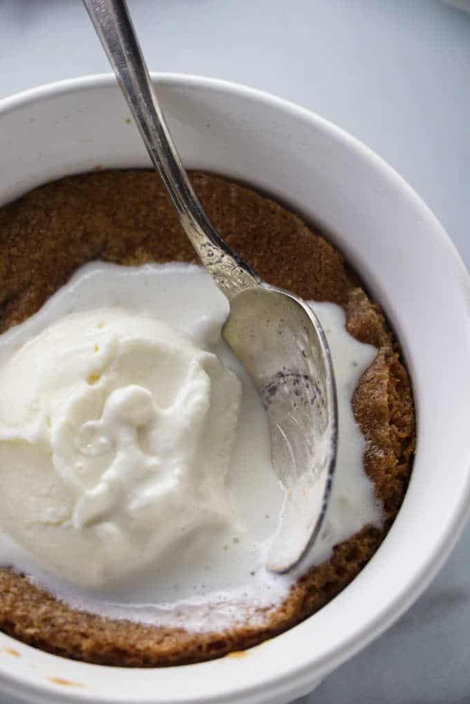 Deep dish chocolate chip cookie bowl with melted ice cream.