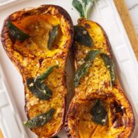 Two halves of a butternut squash on a serving plate.