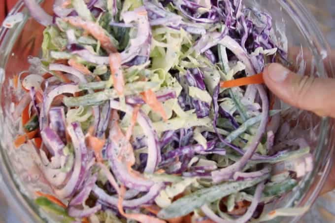 dressed jalapeño lime cilantro slaw in a glass bowl close up