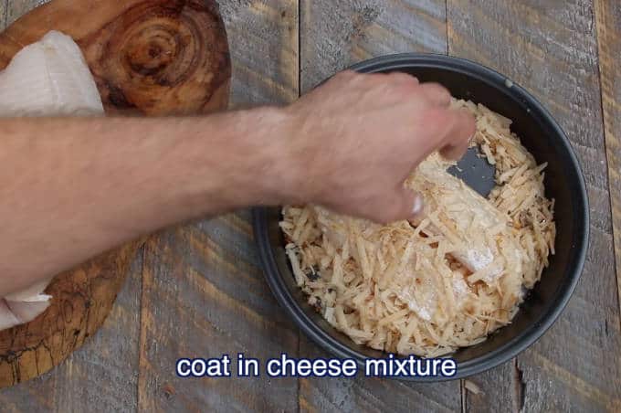 tilapia filet being coated in parmesan cheese