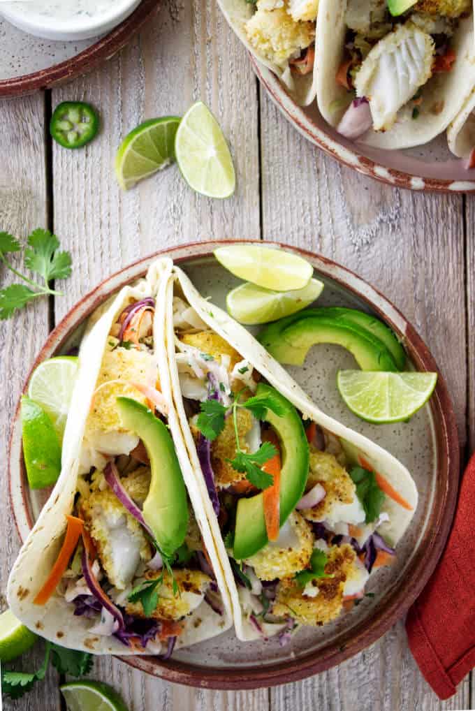 An overhead view of tilapia fish tacos on a plate.