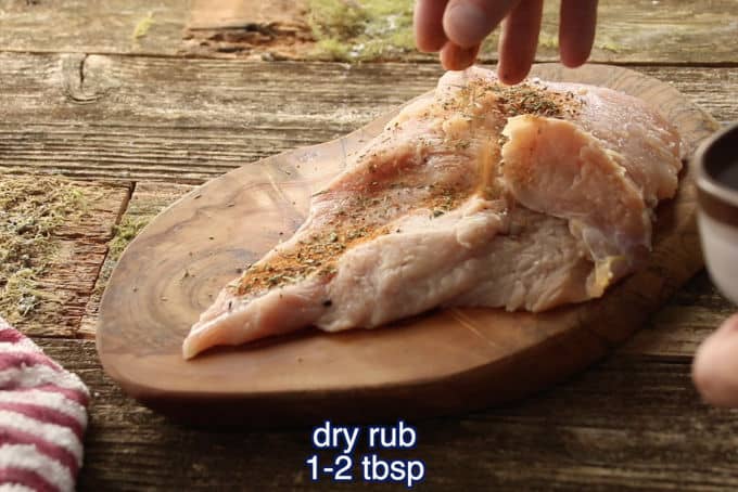 close up of sprinkling dry brine on wild turkey breast