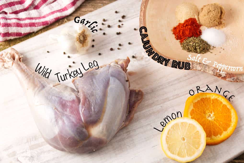 Ingredients for smoked wild turkey legs: cajun dry rub seasoning, salt, peppercorn, wild turkey leg, orange, lemon, garlic