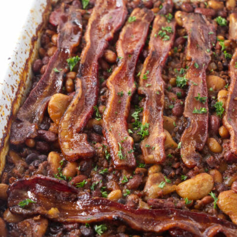 Cowboy baked beans fresh out of the oven with bacon on top.
