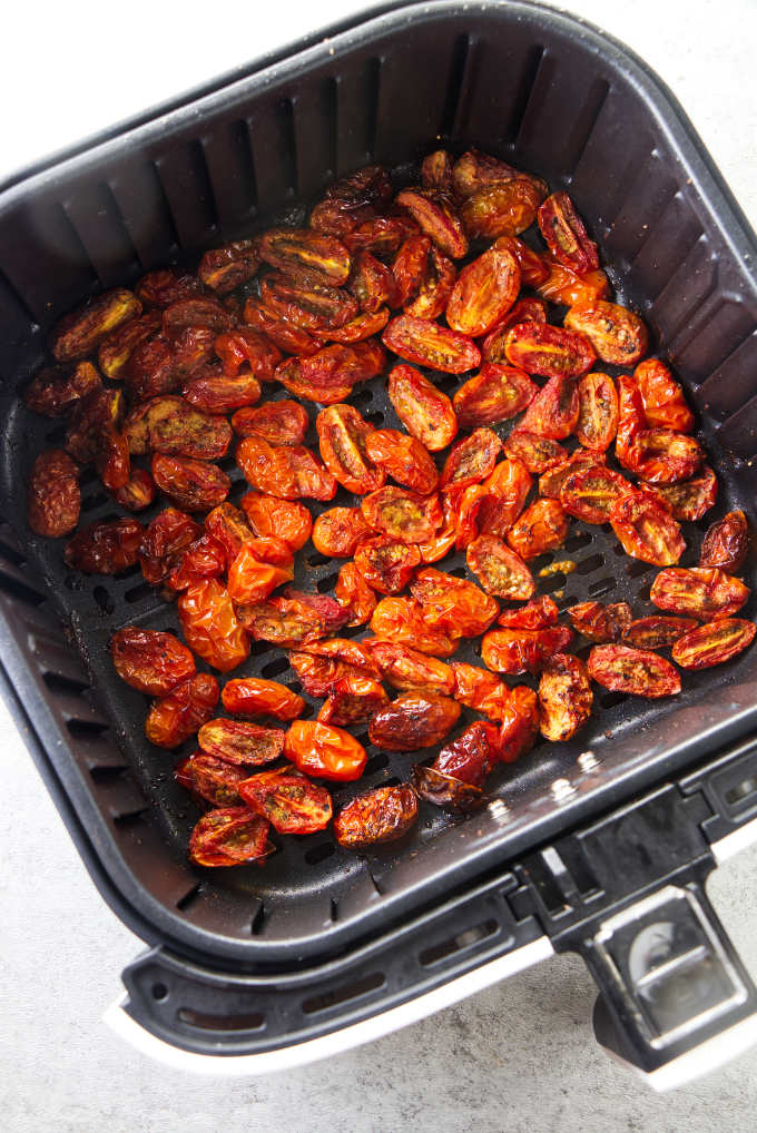 Cherry tomatoes lightly charred in an air fryer.