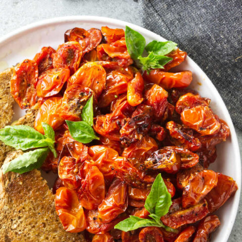 A plate of air fryer cherry tomatoes with toast.