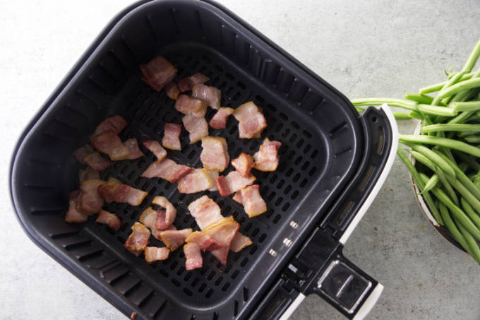 Cooking bacon bits in an air fryer.