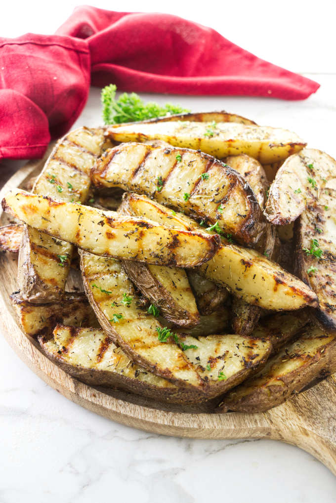 A serving platter with grilled potatoes.
