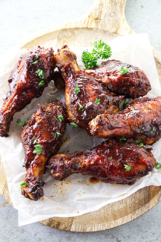 BBQ chicken legs on a serving platter.