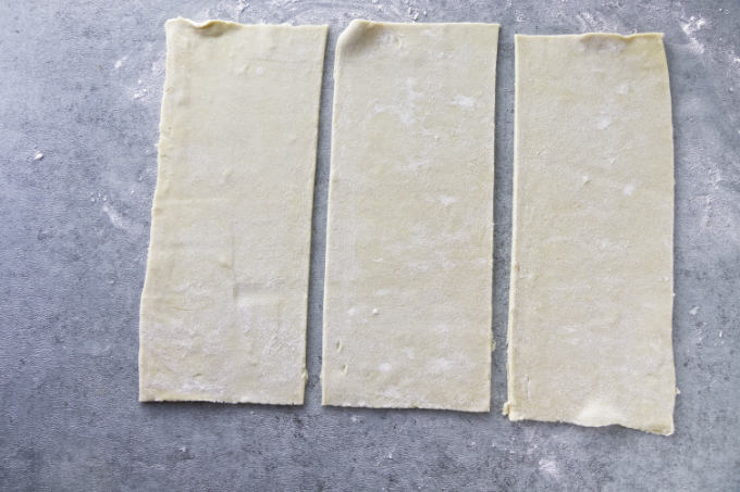 Slicing a puff pastry into three rectangles.