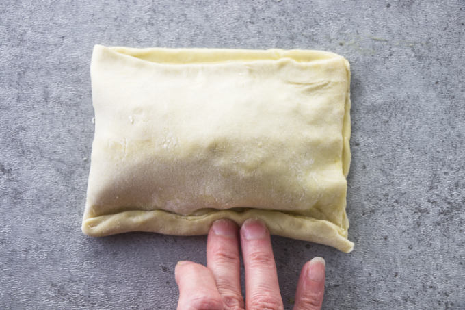 Folding the edges over to seal a breakfast pocket.