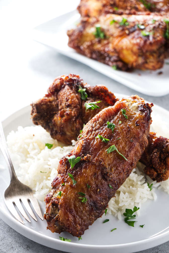 Air fryer turkey wings on a bed of rice.