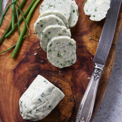 A log of blue cheese butter sliced into rounds for steak.