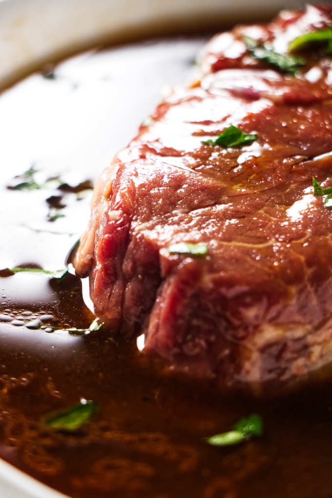 A steak soaking in marinade.