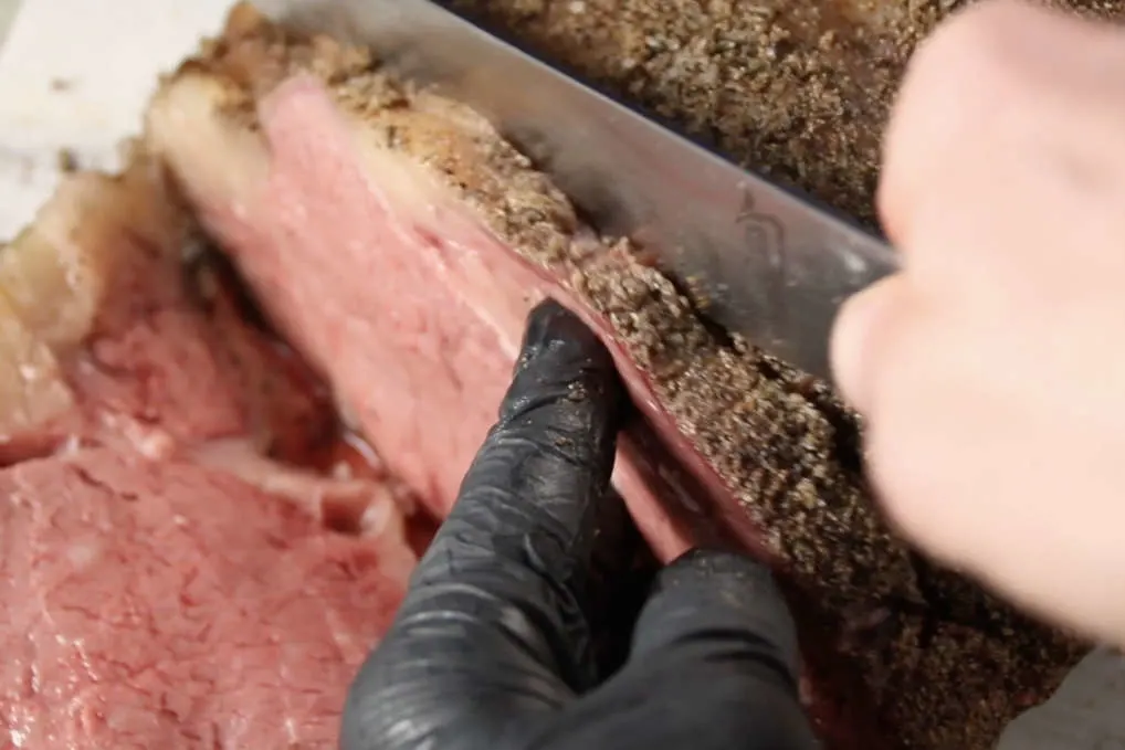 Process photo showing slicing of the Traeger smoked prime rib