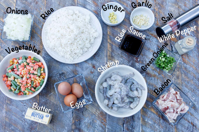blackstone shrimp fried rice ingredients: shrimp, garlic, ginger, green onions, vegetables, bacon, egg, rice sauce, onions, salt, white pepper, rice