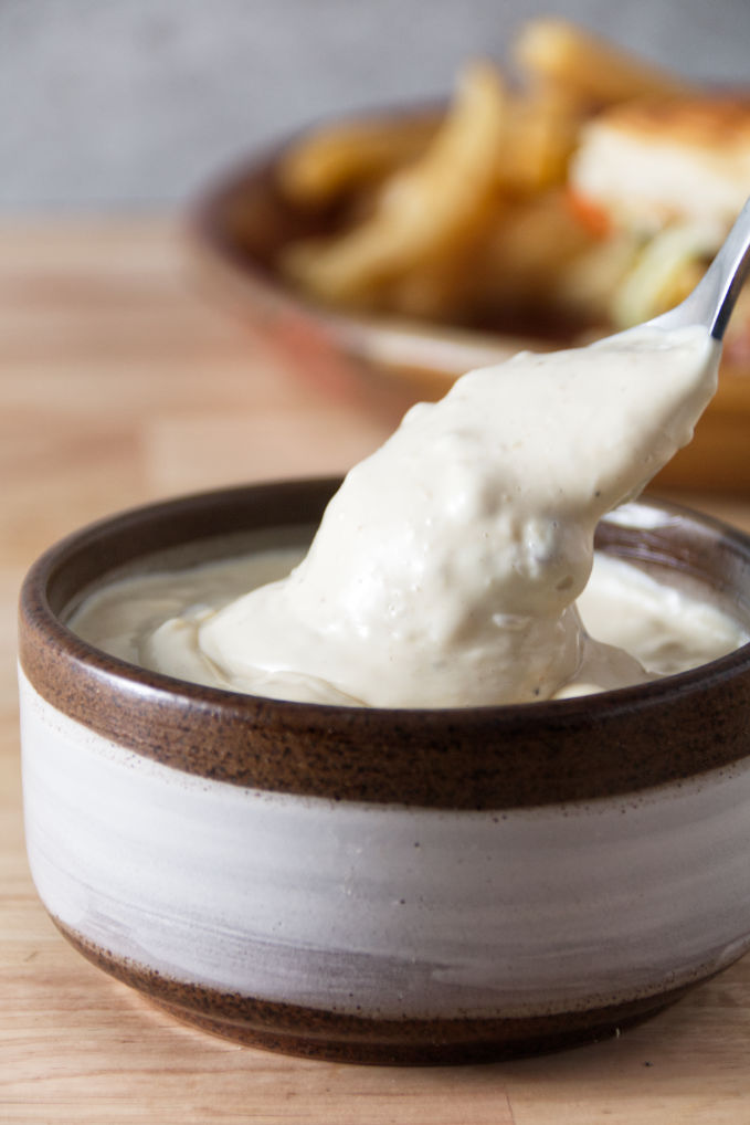 donkey sauce in a ceramic bowl with a spoon dipping in