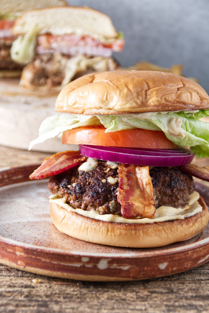 two burgers sitting on plates