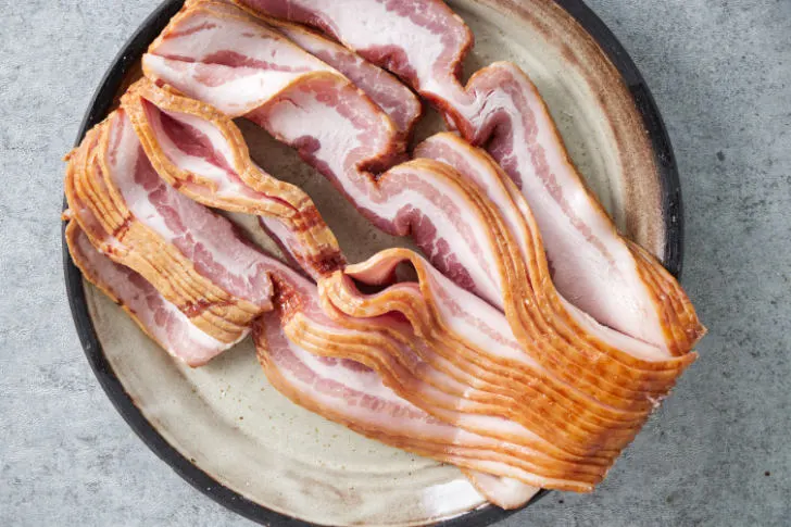 A plate of thin cut bacon.