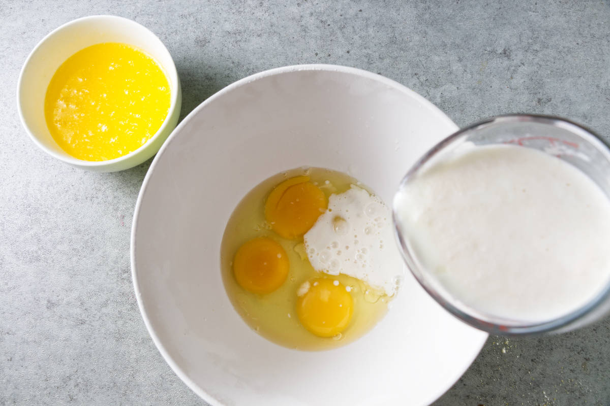 Combining buttermilk, eggs, and butter.