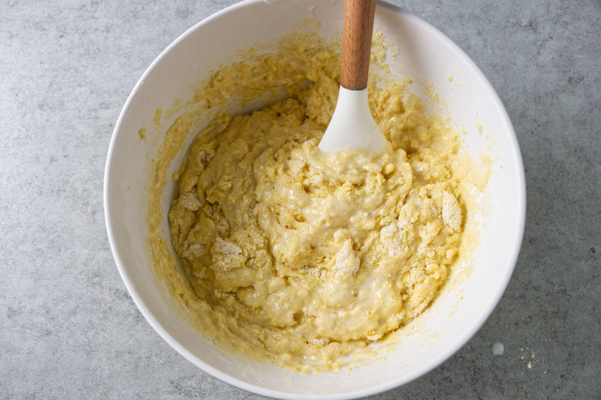 Folding dry ingredients into the liquid ingredients for cornbread.