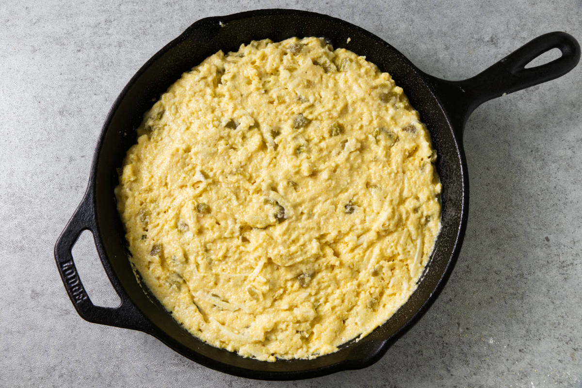 Cornbread batter in a cast iron skillet.