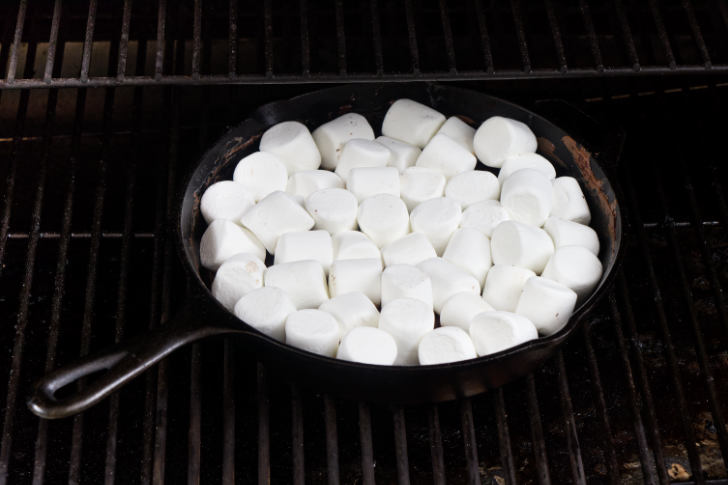 Marshmallows and chocolate in a skillet on a Traeger.