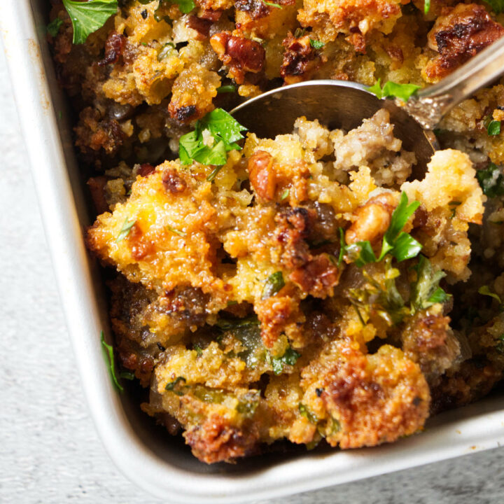 A spoon in a dish of stuffing.