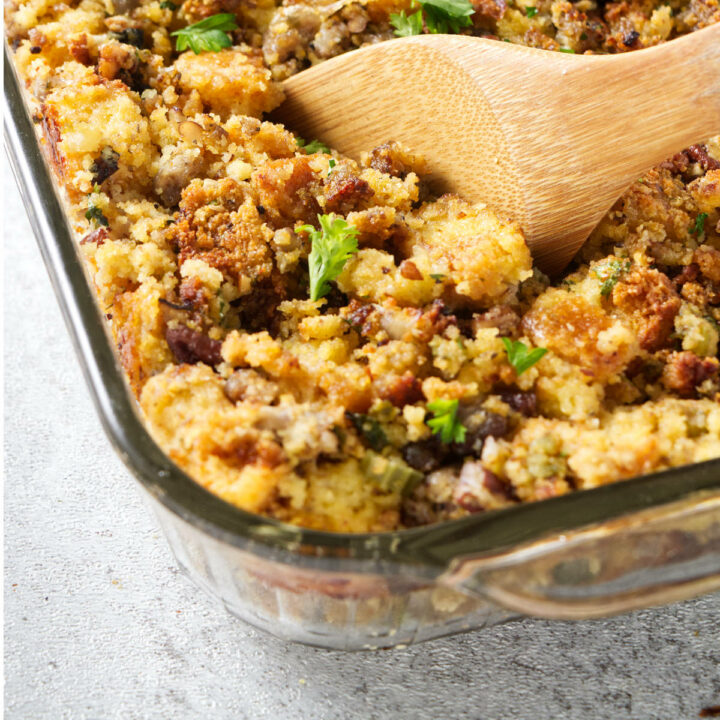 A spoon scooping out some cornbread stuffing.