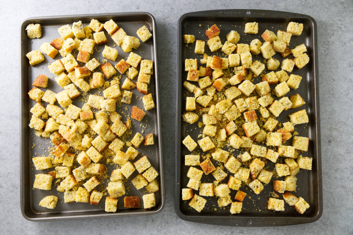 Cubes of cornbread on baking trays.