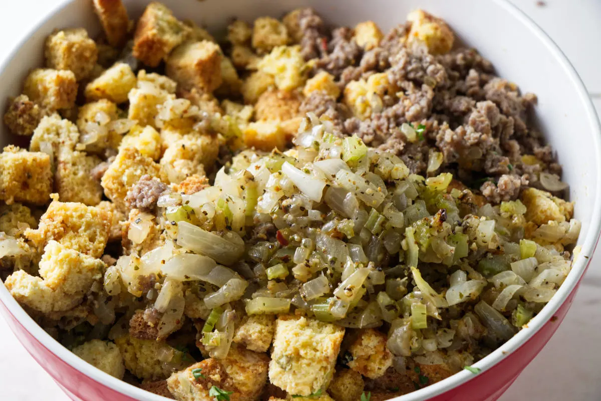 Combining stuffing mixture in a bowl.