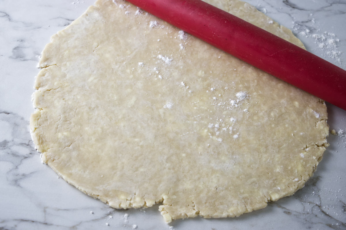 Rolling out a pie crust.