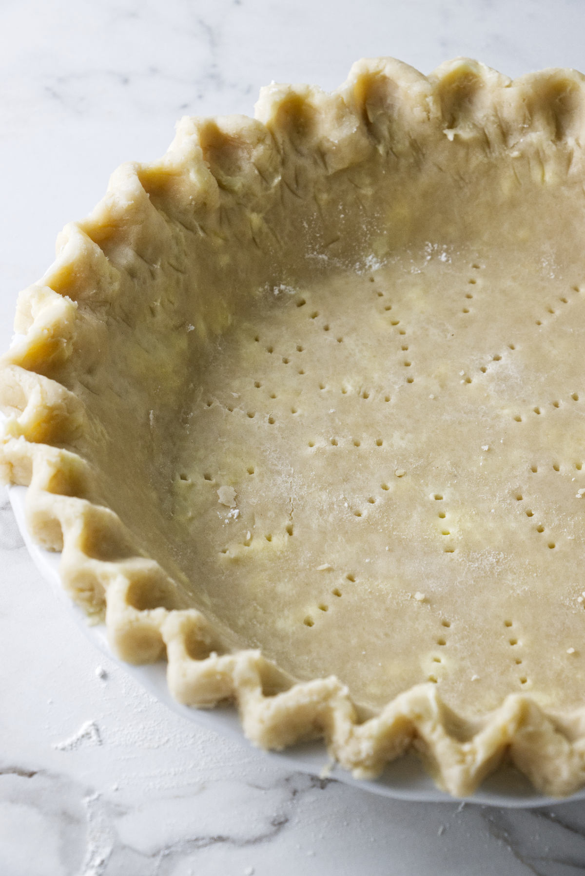 Raw pie dough in a pie plate.