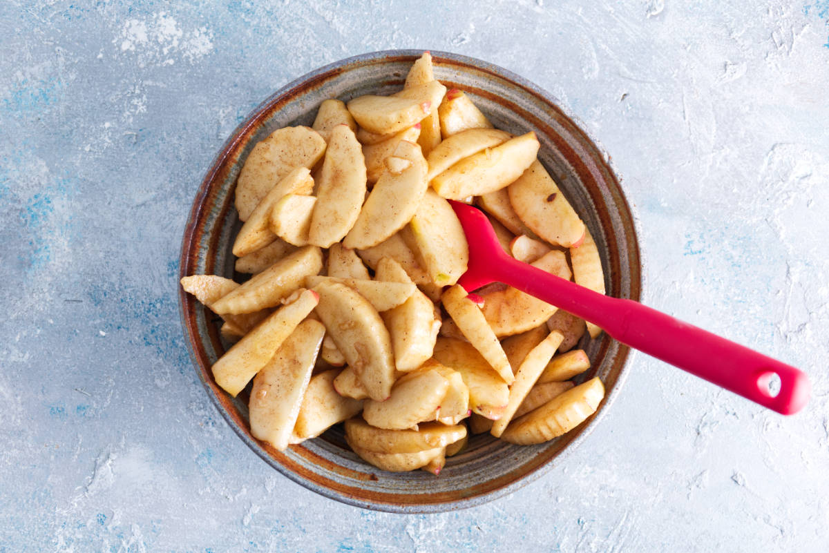 mixing the sliced apples with the rest of the apple pie filling