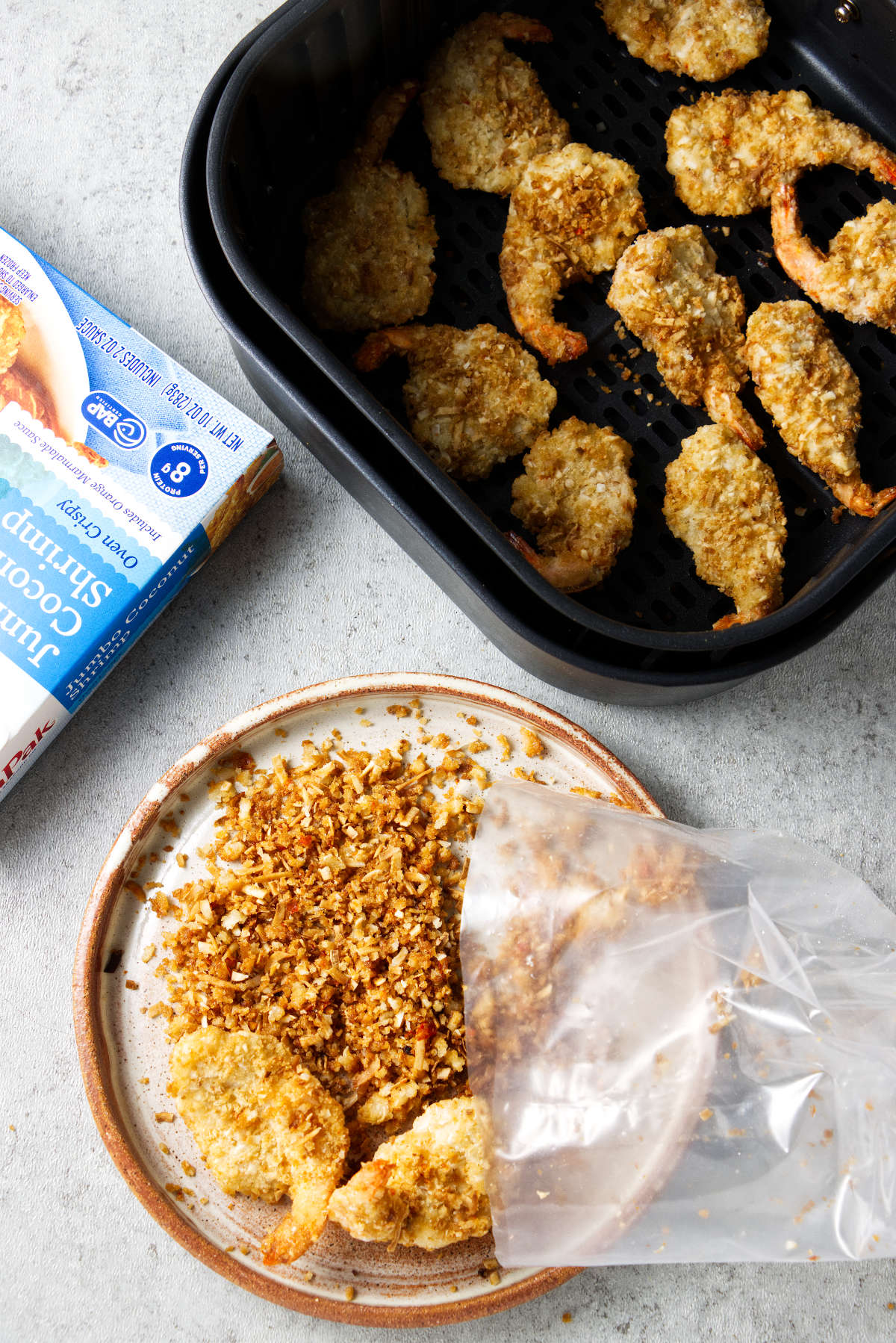 Sorting the crumbs out of frozen coconut shrimp.