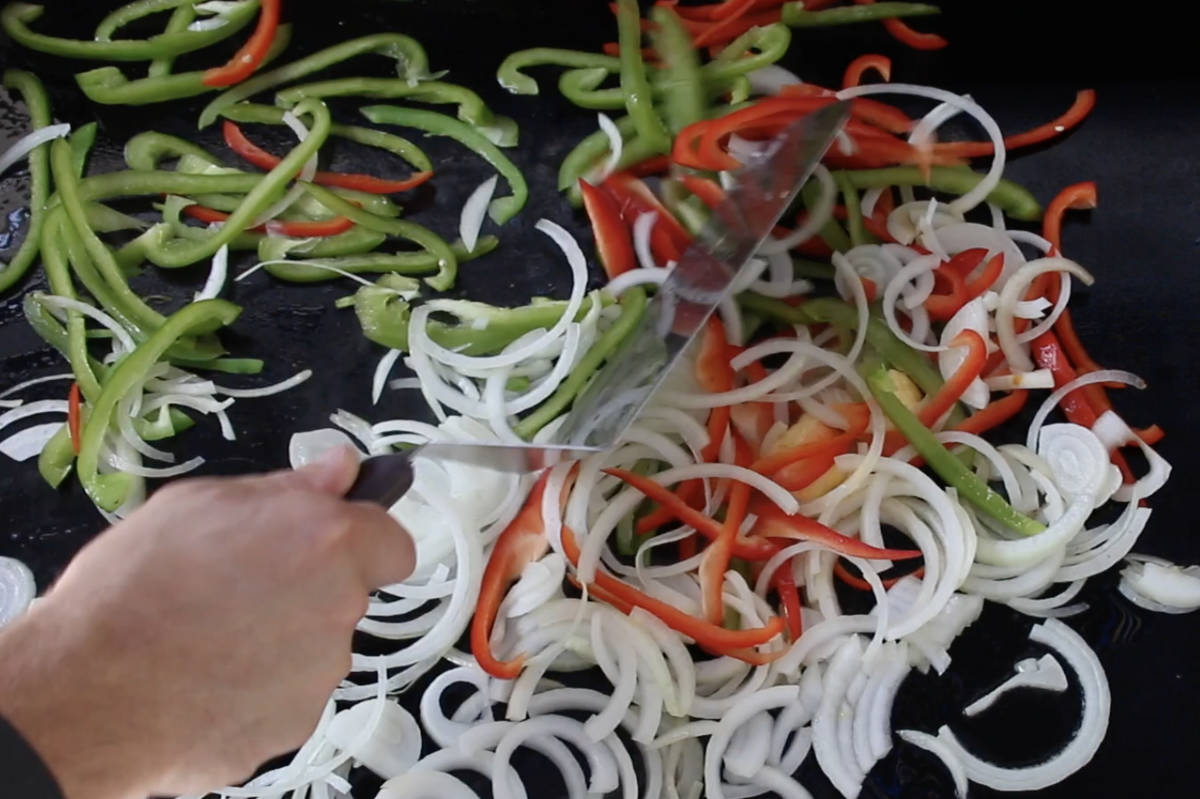 sautéing onions, green peppers, and red peppers on the Blackstone griddle