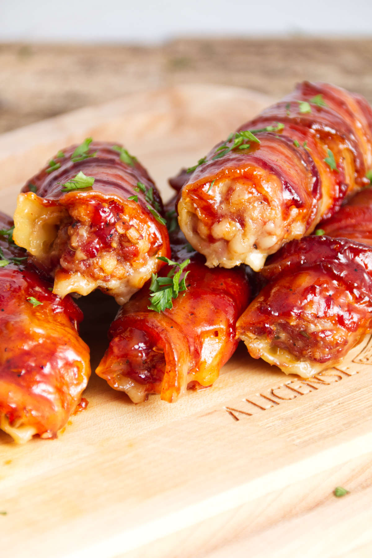 manicotti shells stuffed with sausage and wrapped in bacon and bbq sauce