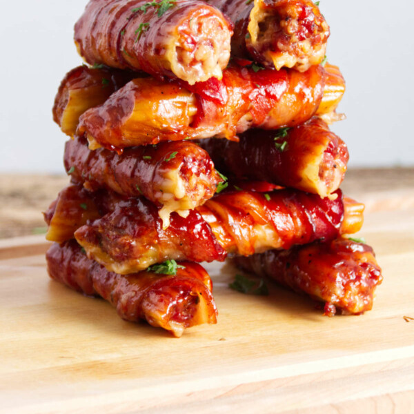 stacked sausage stuffed manicotti shells wrapped in bacon and BBQ sauce