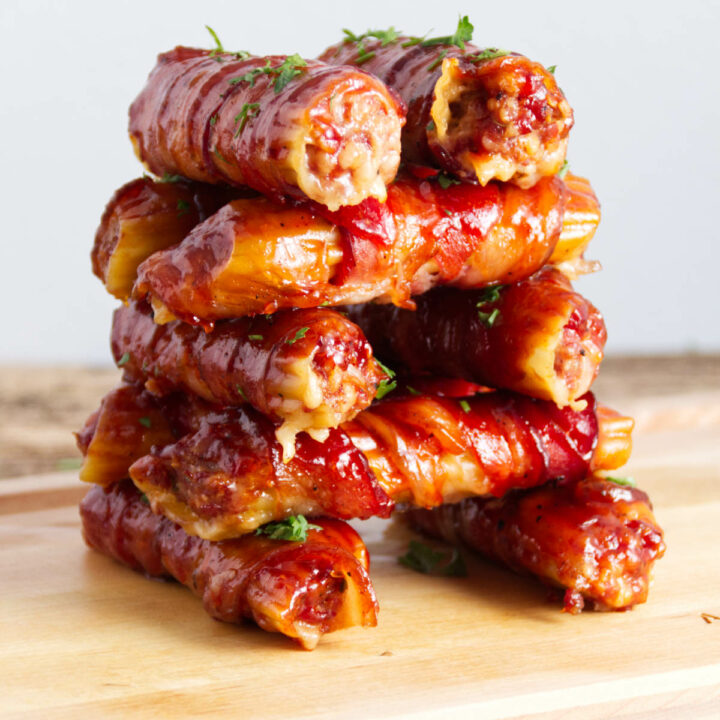 stacked sausage stuffed manicotti shells wrapped in bacon and BBQ sauce