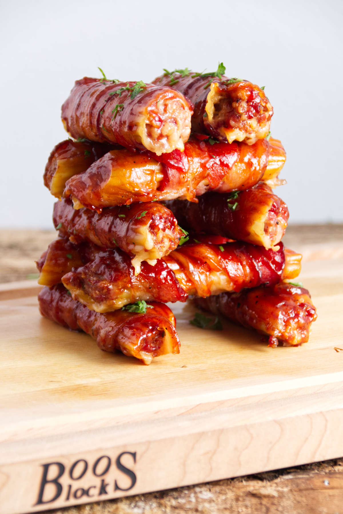 stacked sausage stuffed manicotti shells wrapped in bacon and BBQ sauce